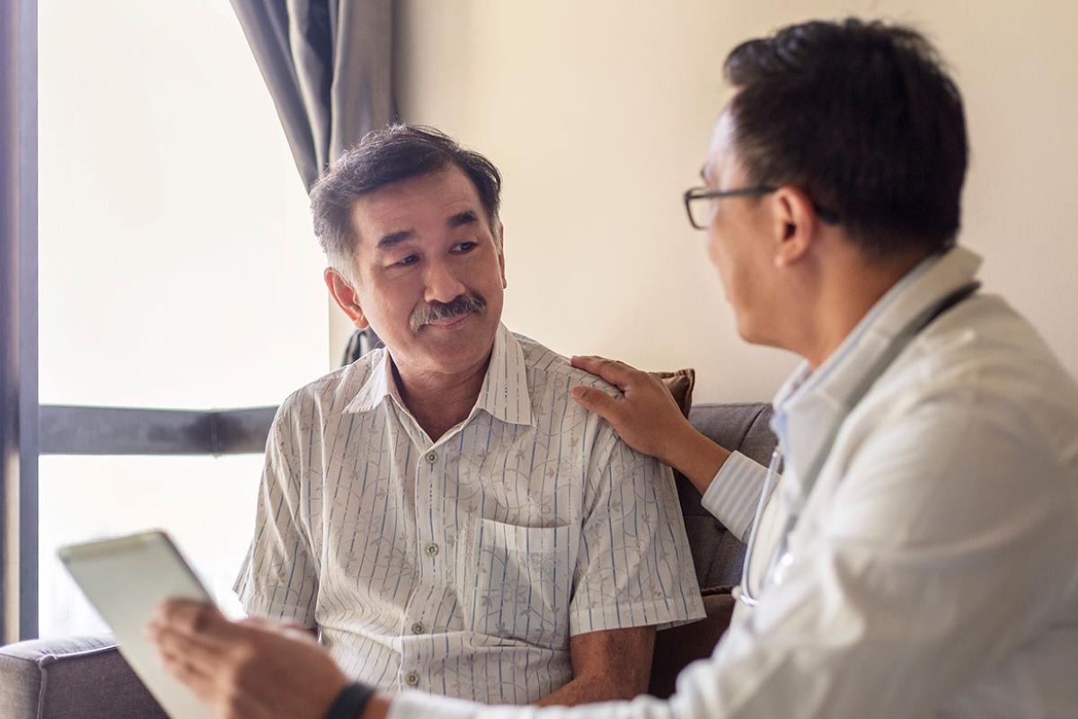 Physician with hand on patient's shoulder